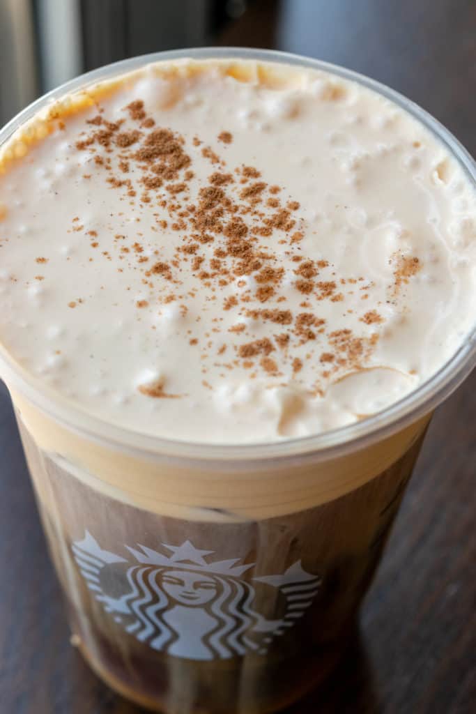 Pumpkin Cream Cold Brew drink at Starbucks topped with pumpkin cream and pumpkin spices.
