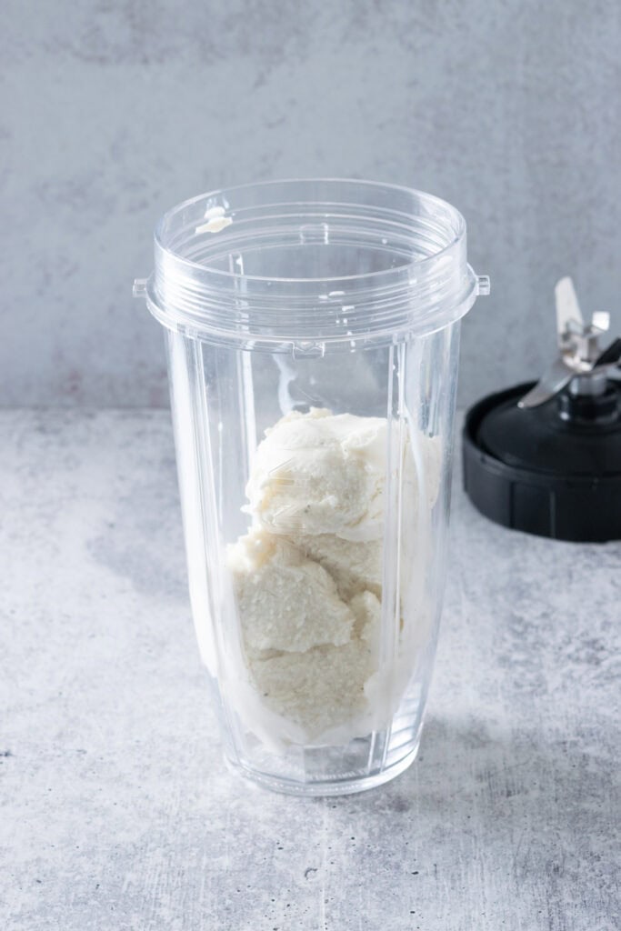 Vanilla ice cream in a blender container.