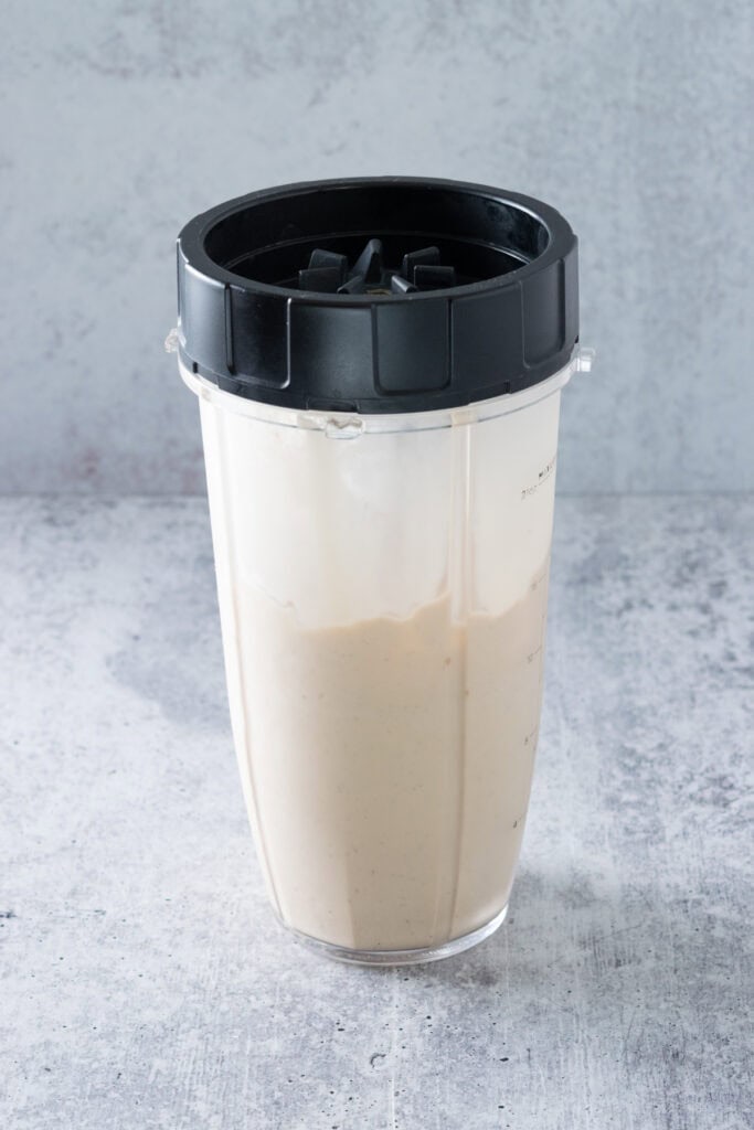Blended coffee milkshake still in blender container.