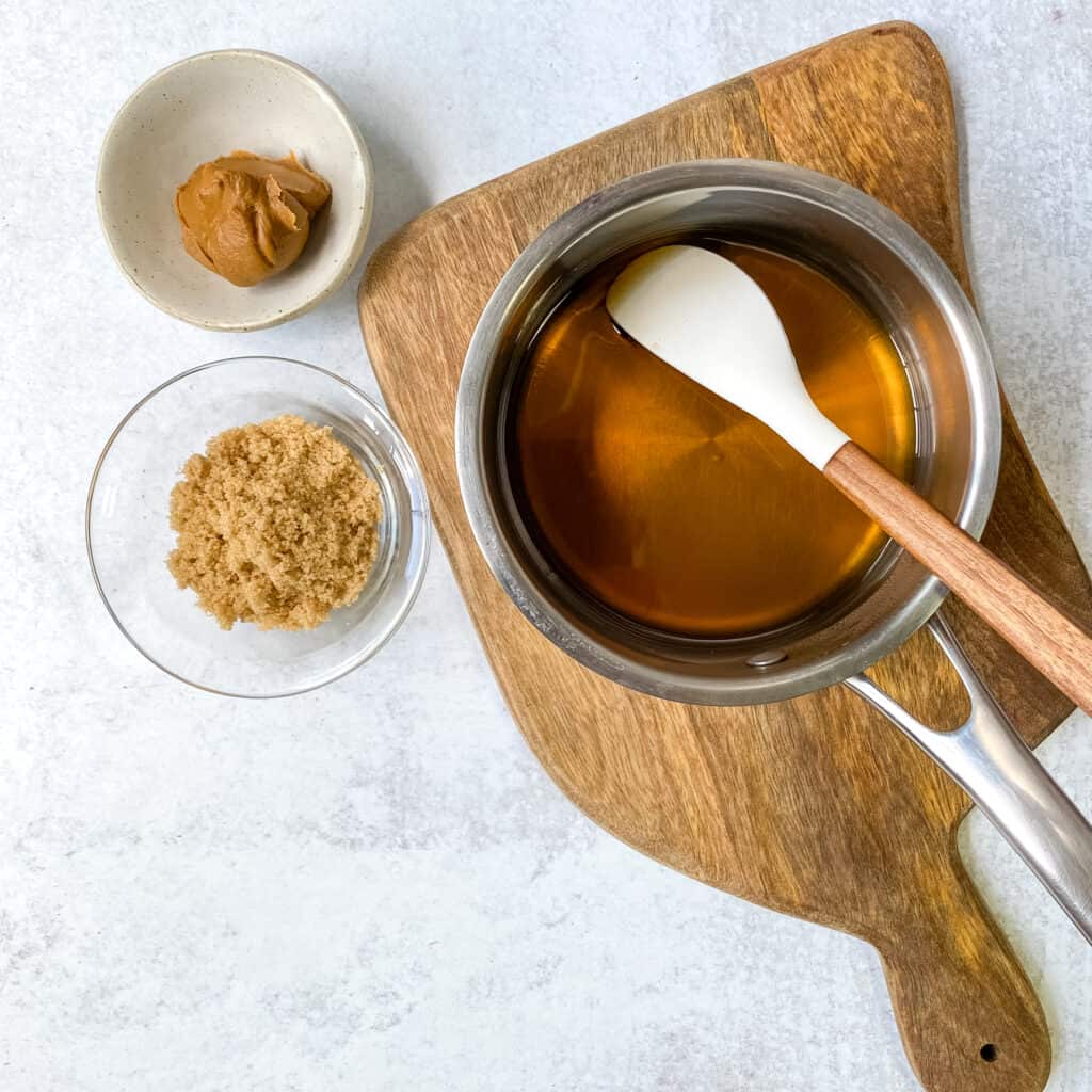 Water added to brown sugar in saucepan to make cookie butter syrup.