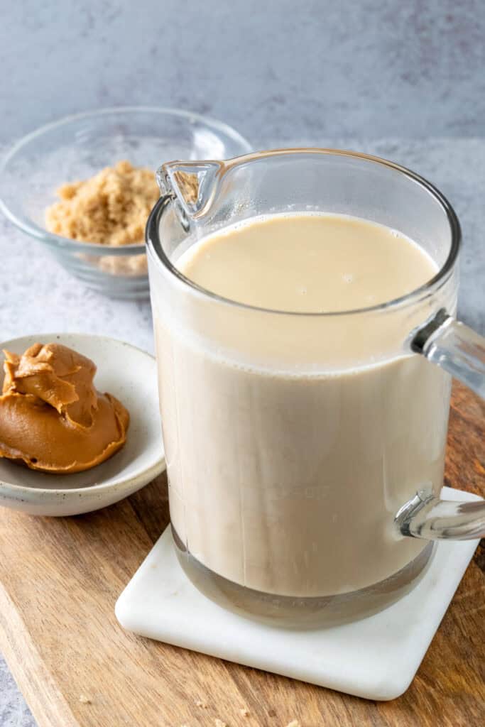 Homemade cookie butter spread in a 2-cup glass measuring cup, showing how much the recipe makes.