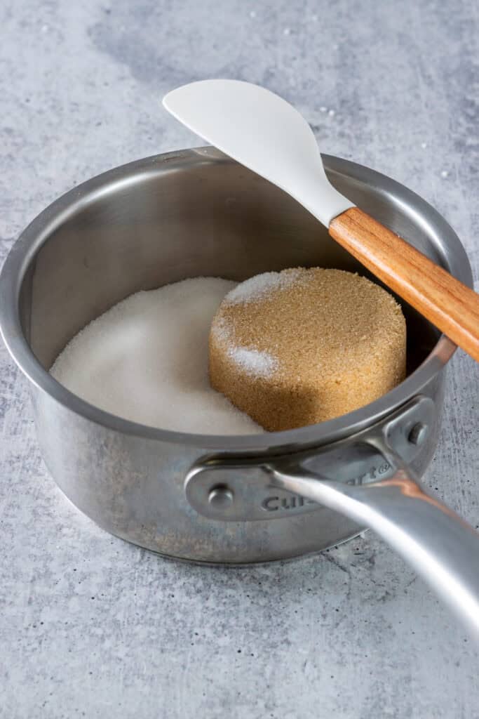 White sugar and brown sugar in a small saucepan.