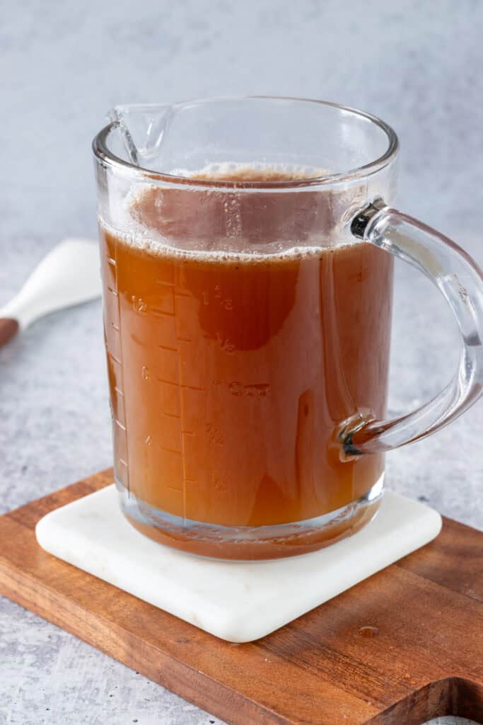 A glass measuring cup showing that the recipe made 2 cups of homemade syrup.